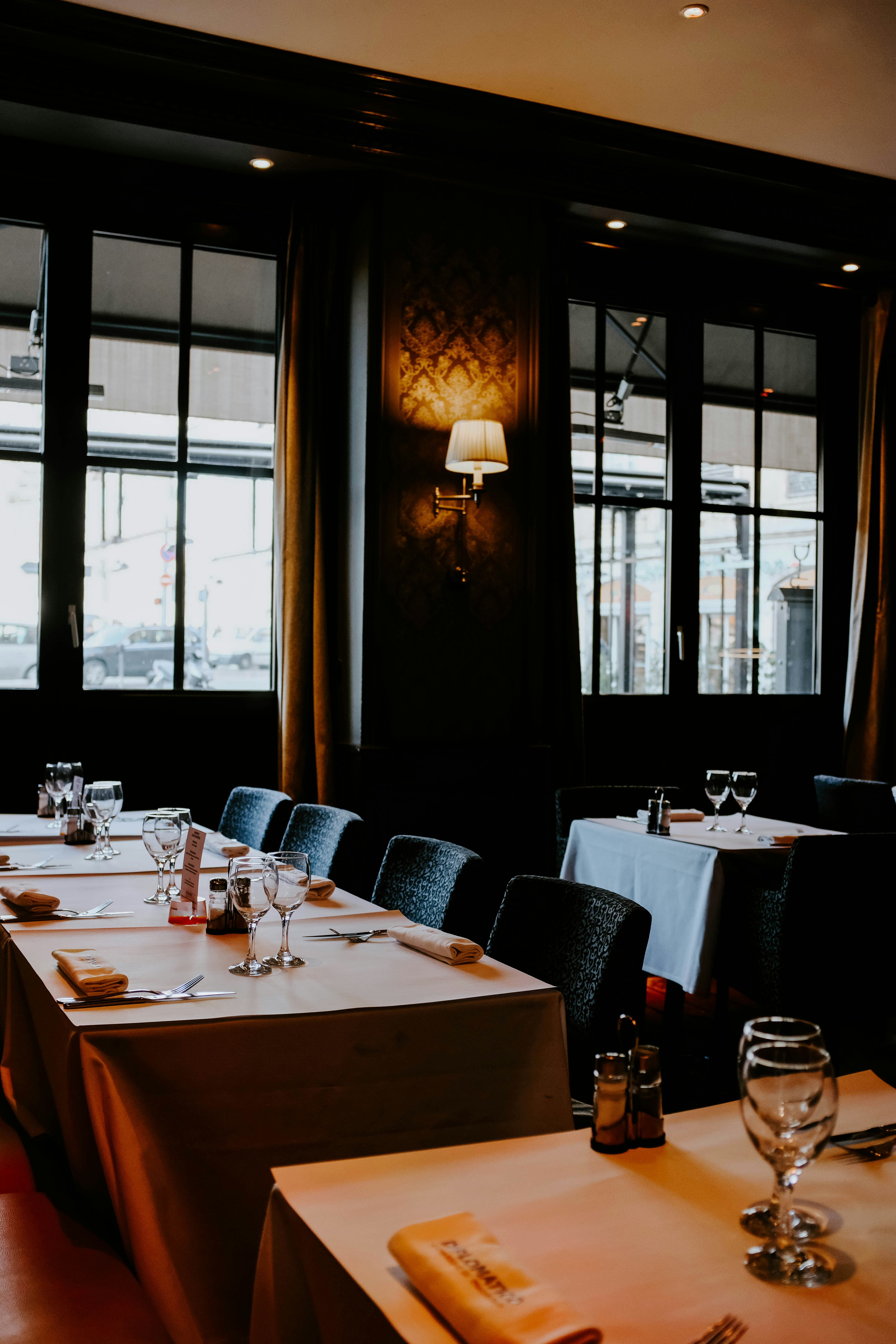 wine glasses and utensils on dining tables